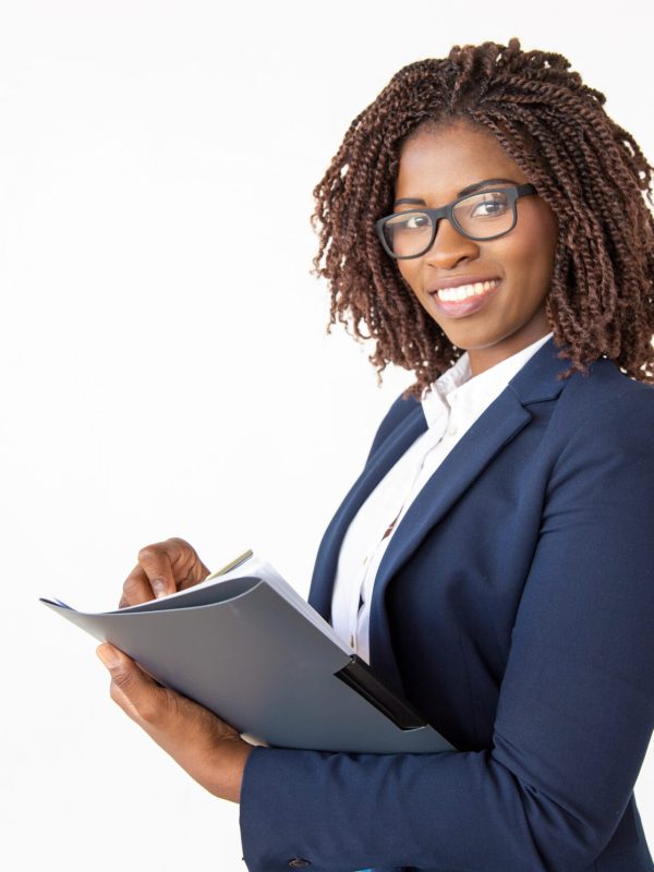 Happy expert checking documents, taking notes in paper, holding pen and folder. Young African American business woman posing isolated over white background. Paperwork concept